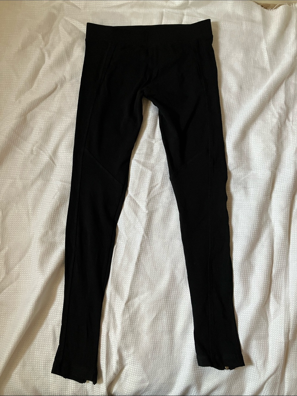 Black stretch leggings with zipper at the bottom